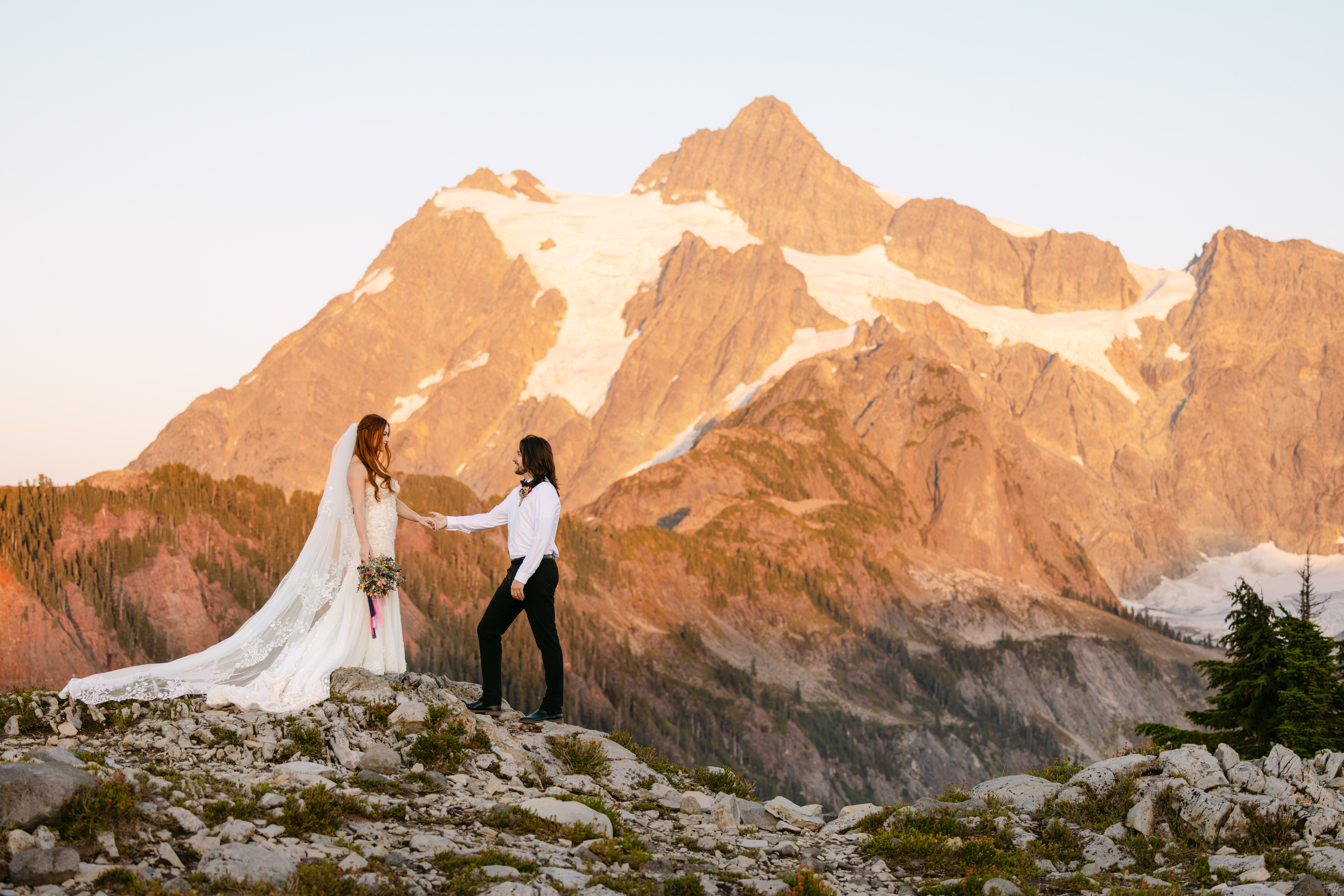 Couple holding hands at sunset on Artist Point with Mount Baker in the background