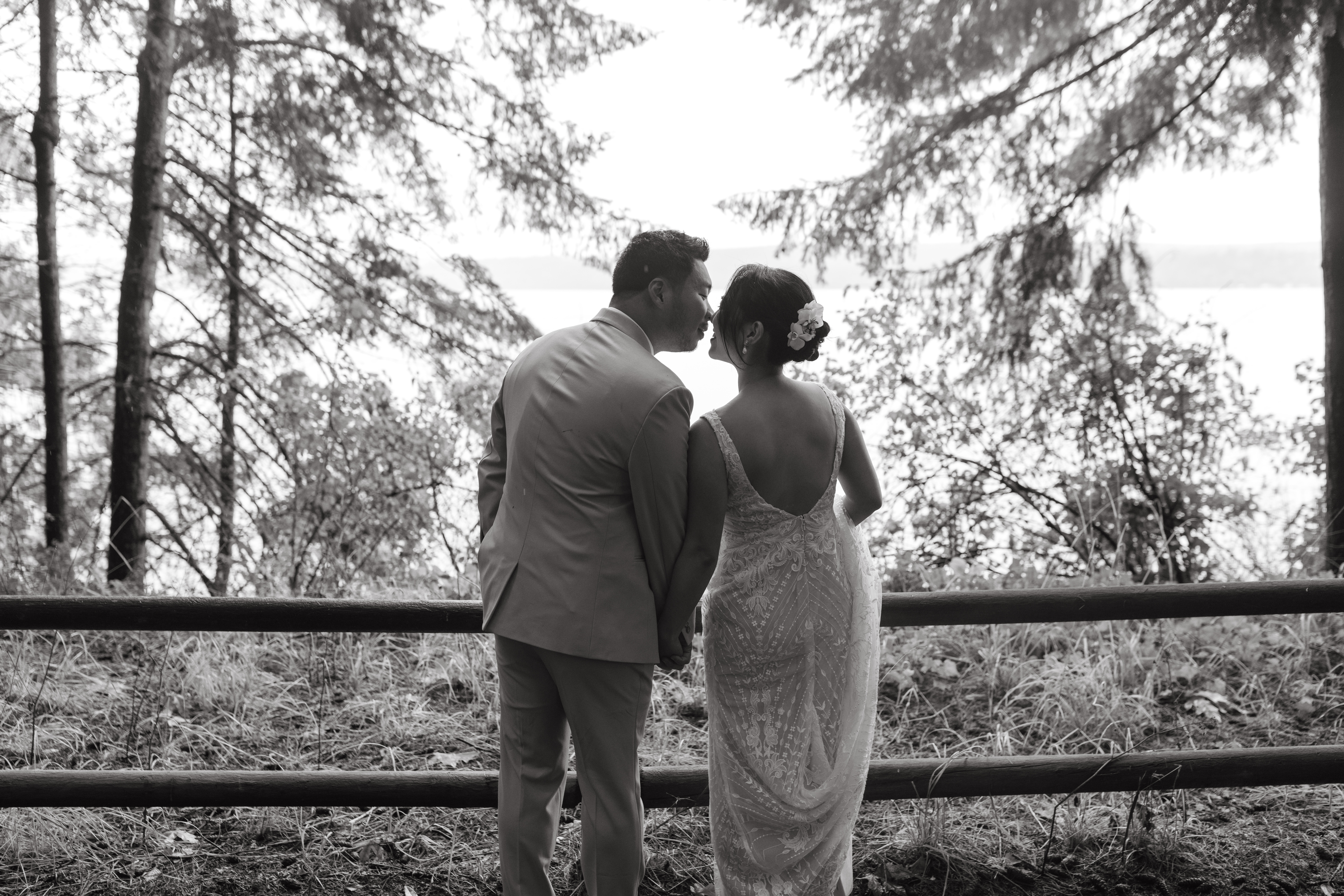 Wedding couple kissing on by the overlook at Kitsap Memorial State Park, Bainbridge Island, Washington.